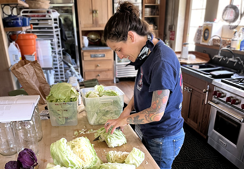 Chef Isabelle Nunes preparing cabbage for fermentation.