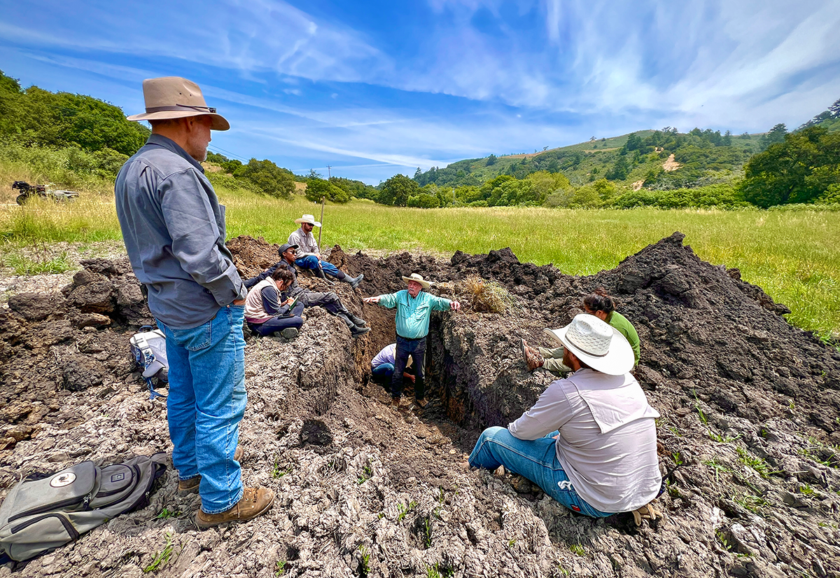 land-management Wendell Gilgert, standing in a trench, describes the various soil types found at TomKat Ranch