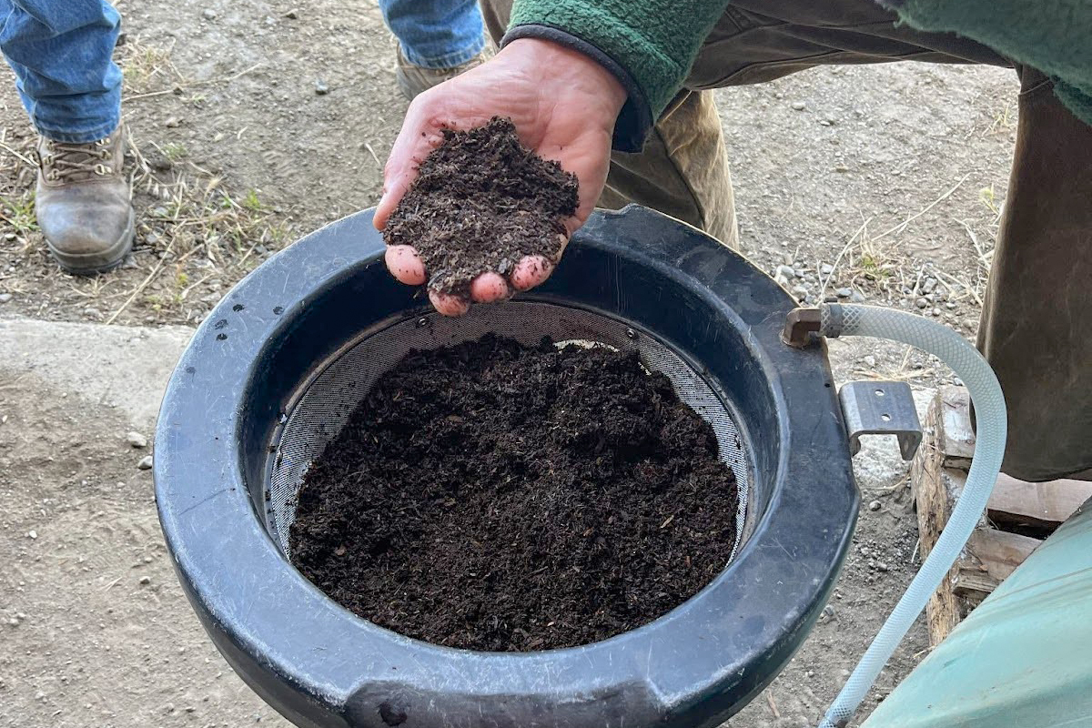 Michael Alms of Growing Solutions takes a handful of the final product.
