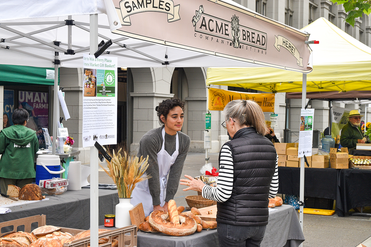 Rachel Sullivan at her family's baked bread booth at the San Francisco Ferry Plaza Farmers’ Market.